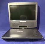 Sylvania Sdvd7040b 7" Portable/car Dvd Player + Case, Charger, Remote, Headphone. Fixed Price $49.99.